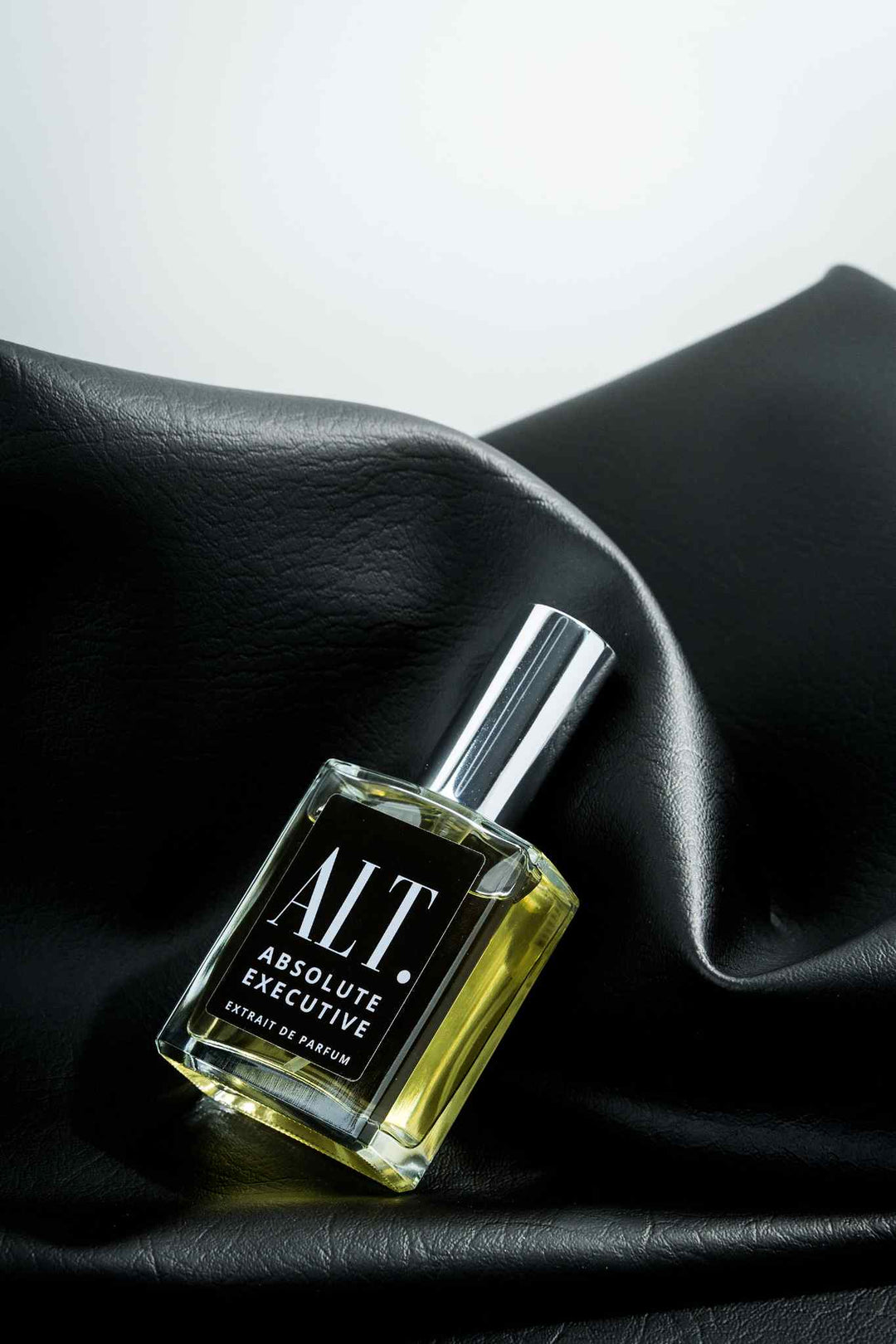 ALT. fragrance bottle on black silk